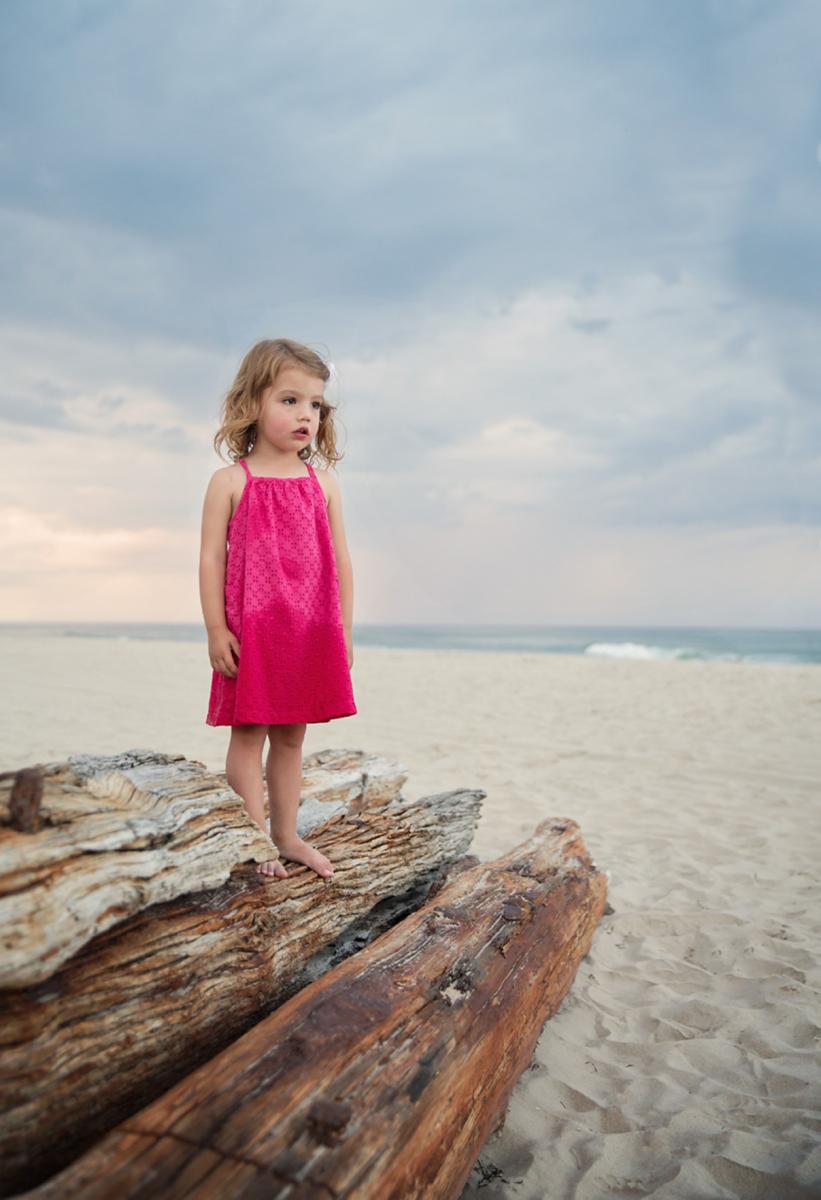 girl standing on shipwreck in Corolla NC