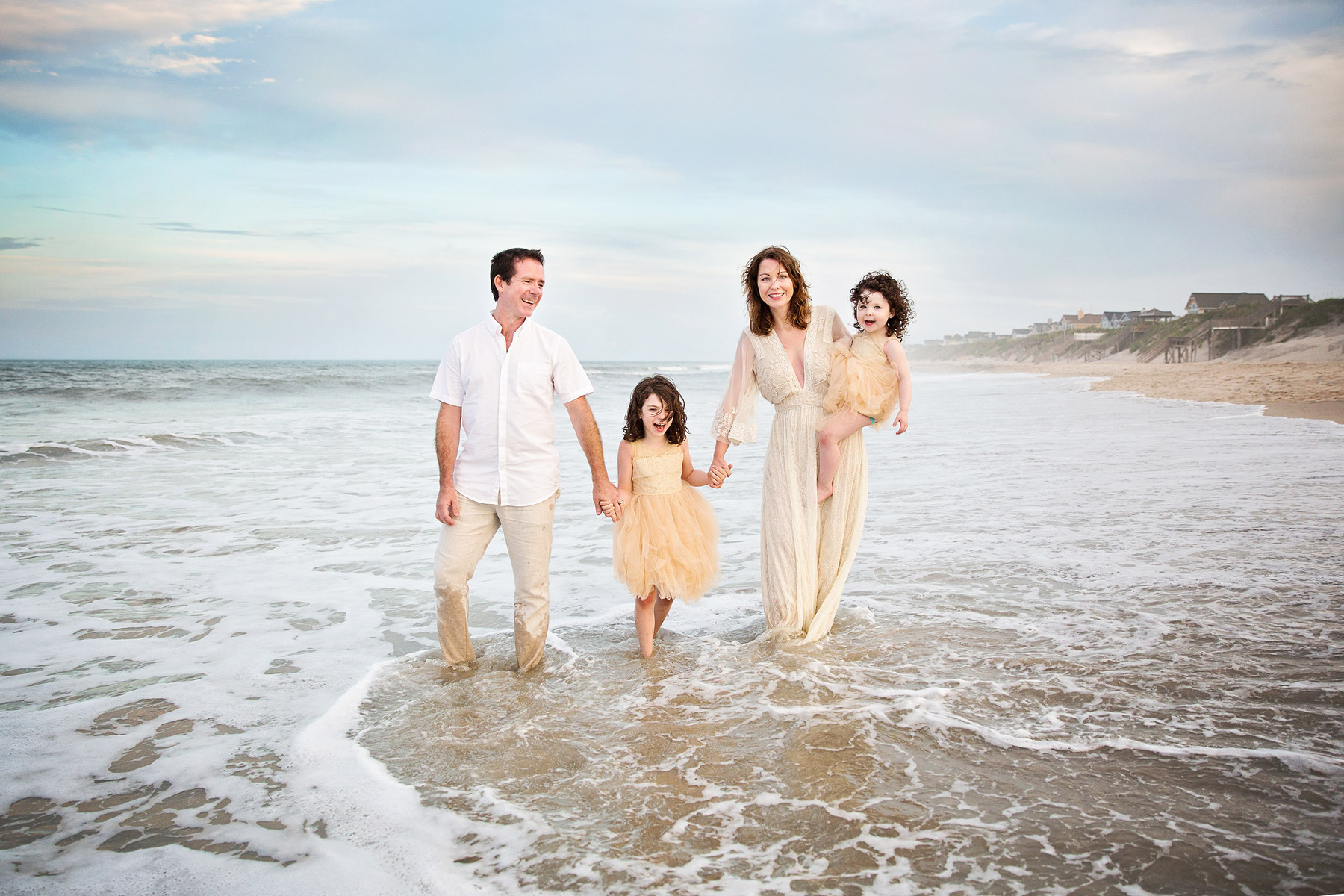 Boho chic family walking on the beach