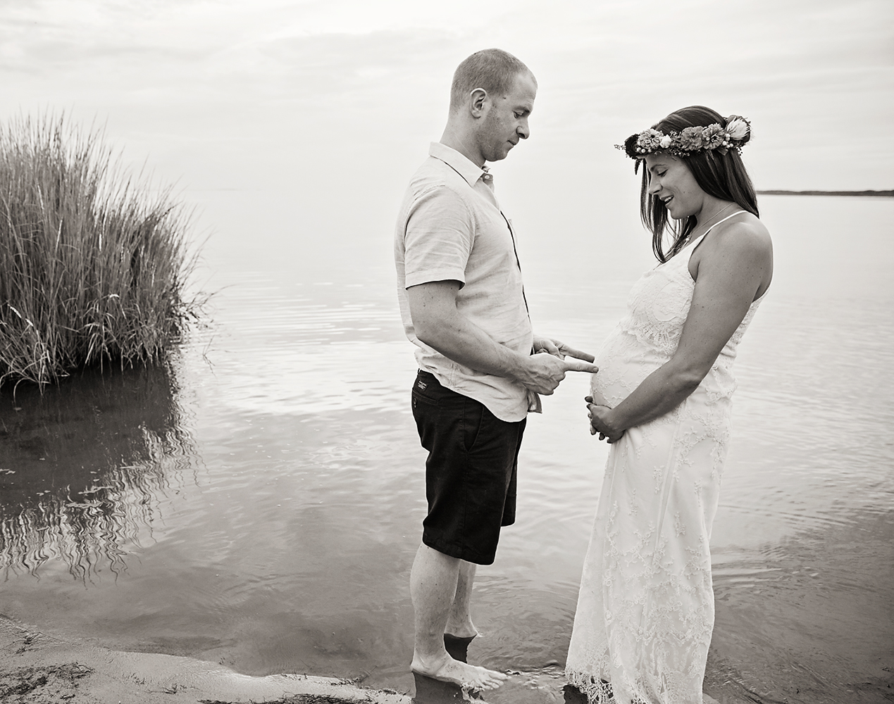 Couple maternity photo on the water at Jockey's Ridge in Nags Head NC