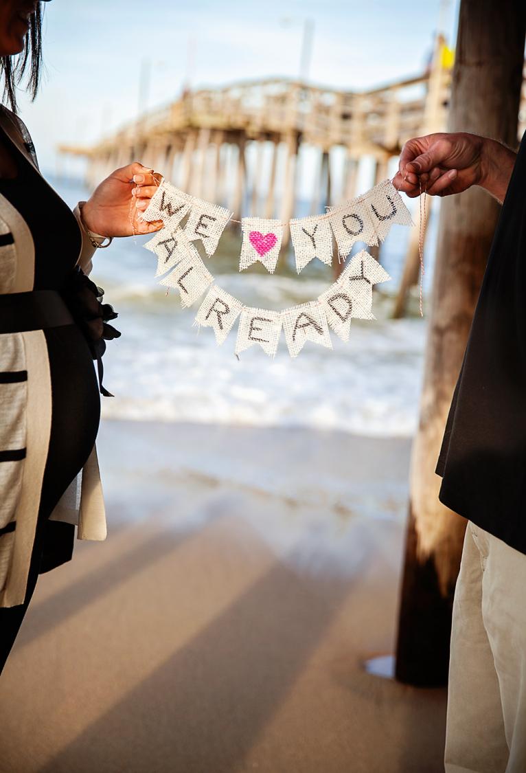 Pregnancy photo of couple at Nags Head Pier
