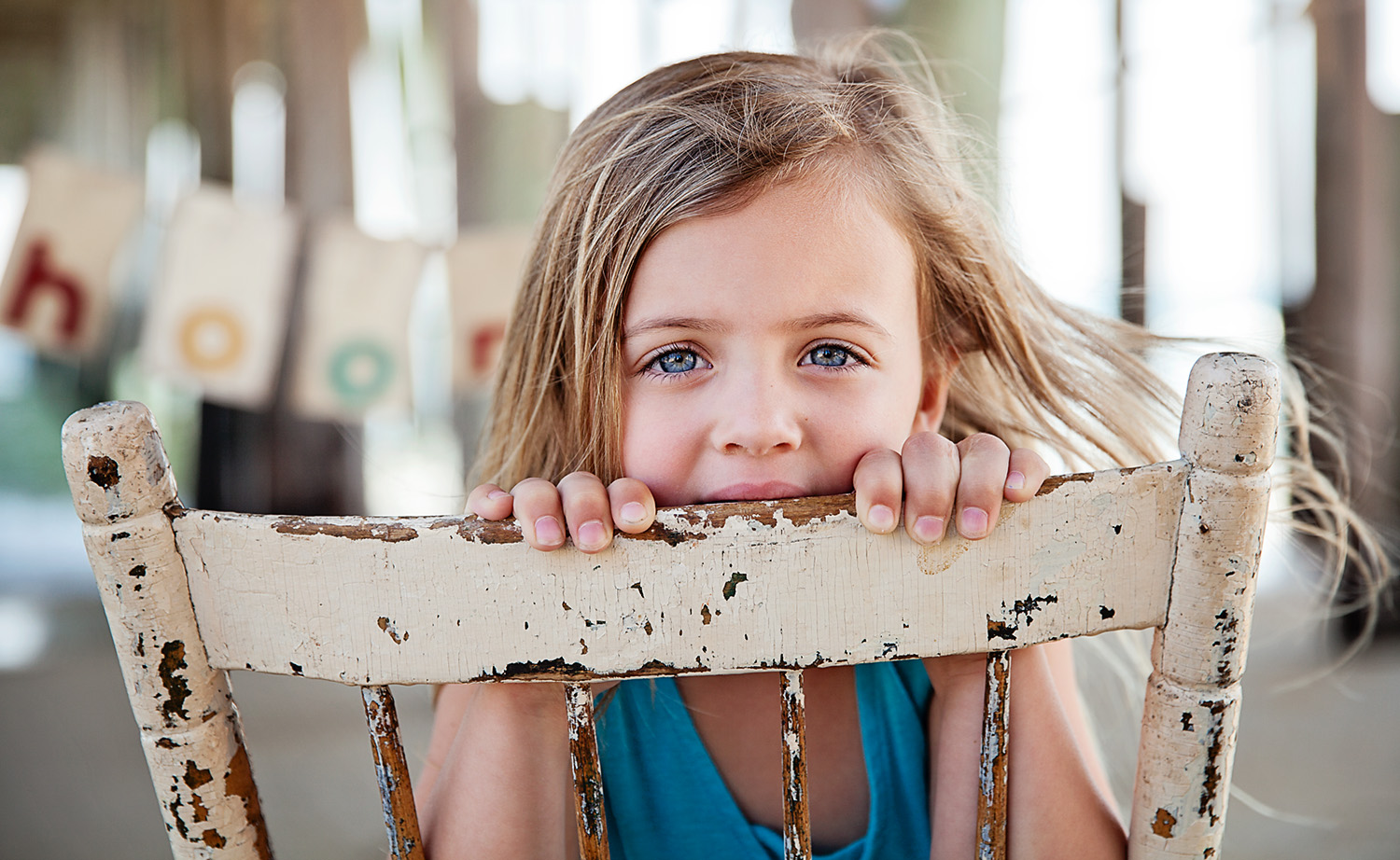 Little girl with blue eyes under Kitty Hawk pier in North Carolina