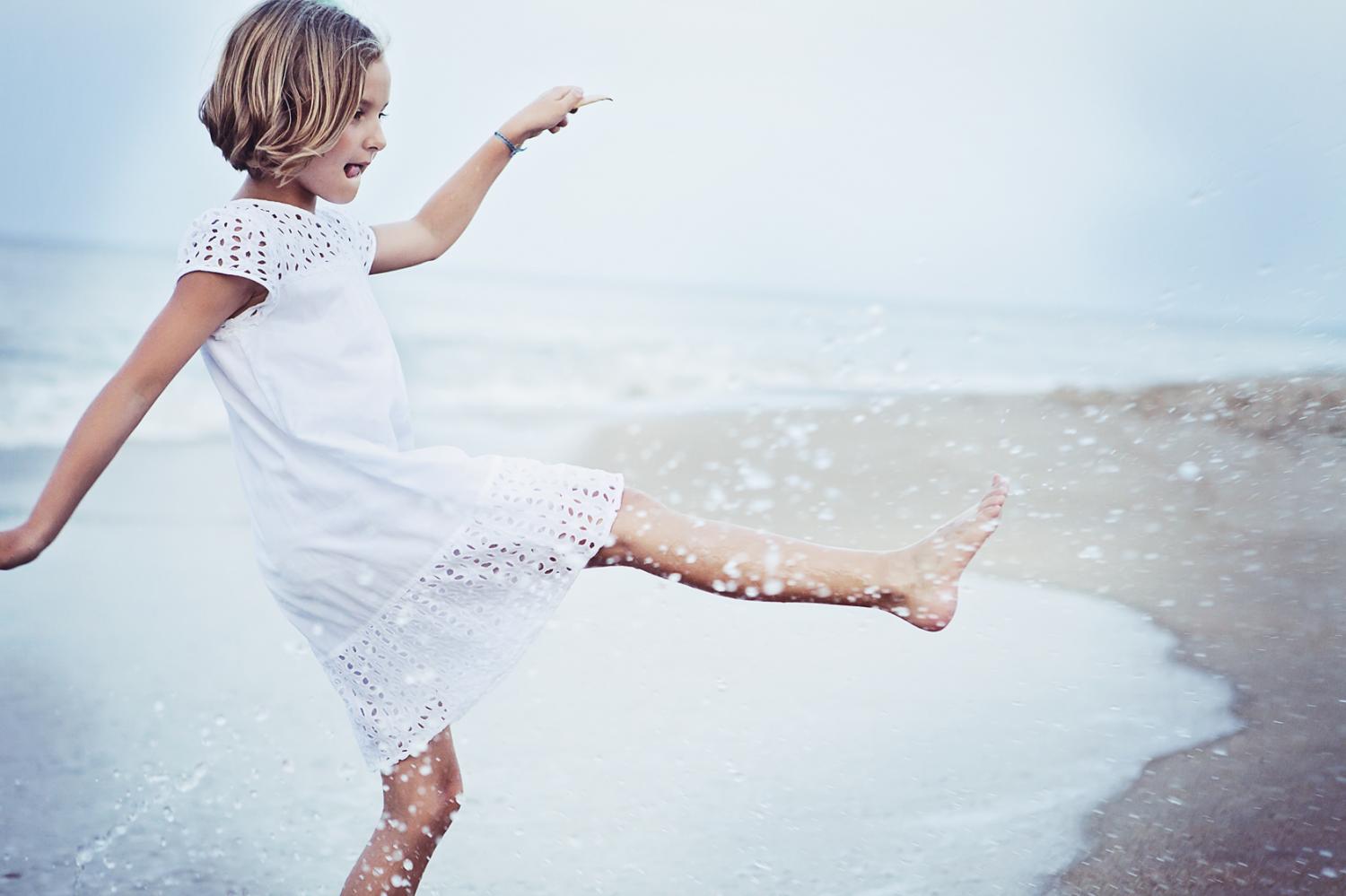 Girl playing by the water in Kill Devil Hills NC