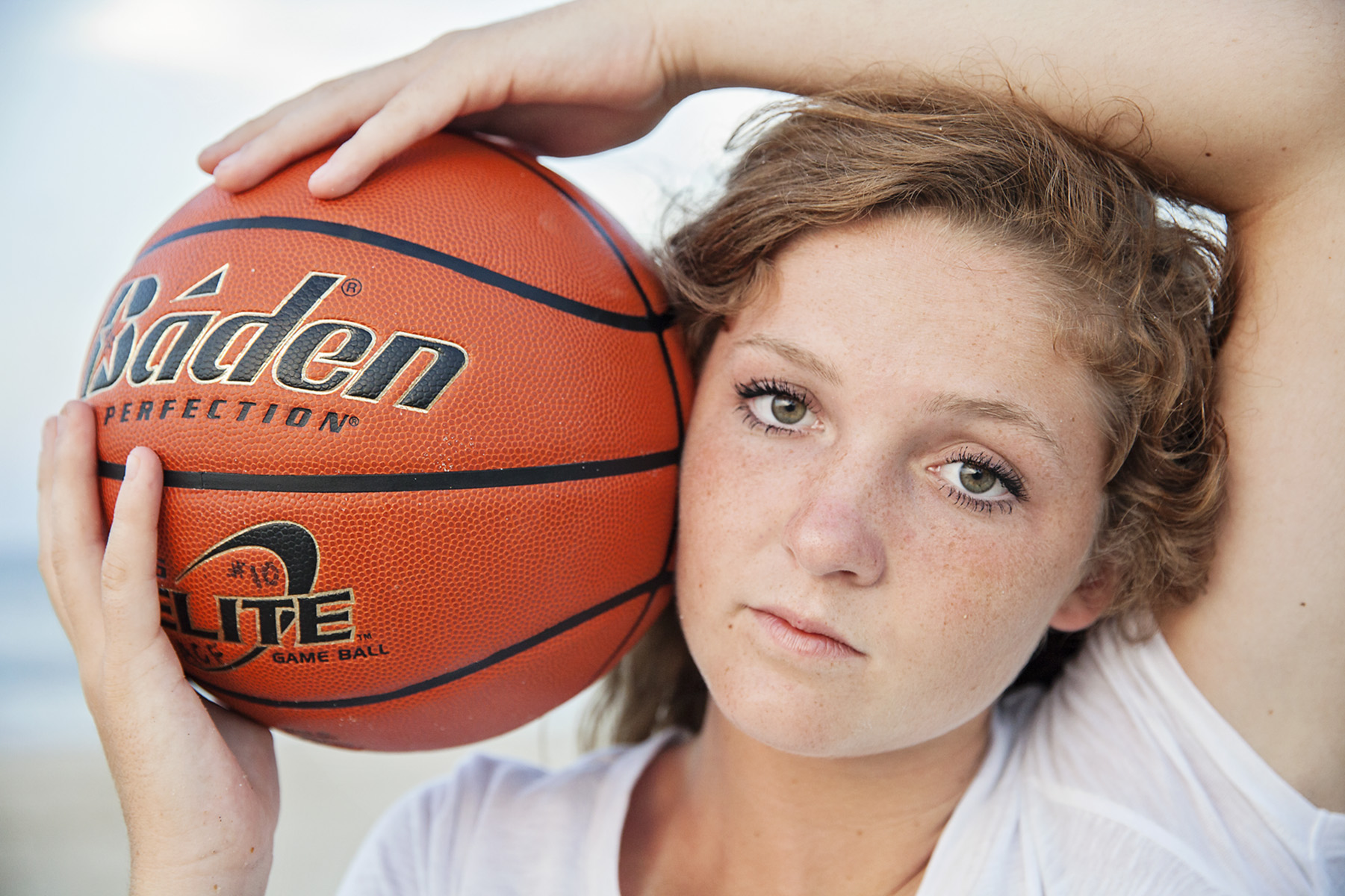 Senior girl holding basketball in Outer Banks, NC