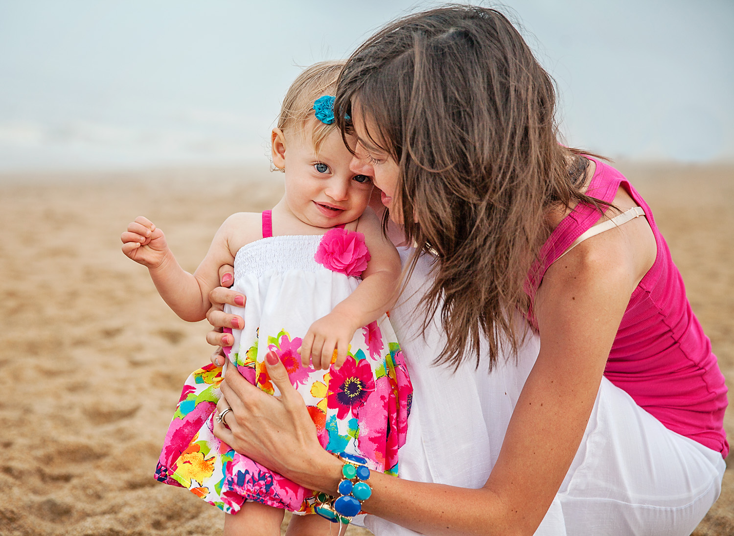 Mom and daughter hugging at the beach in Duck NC