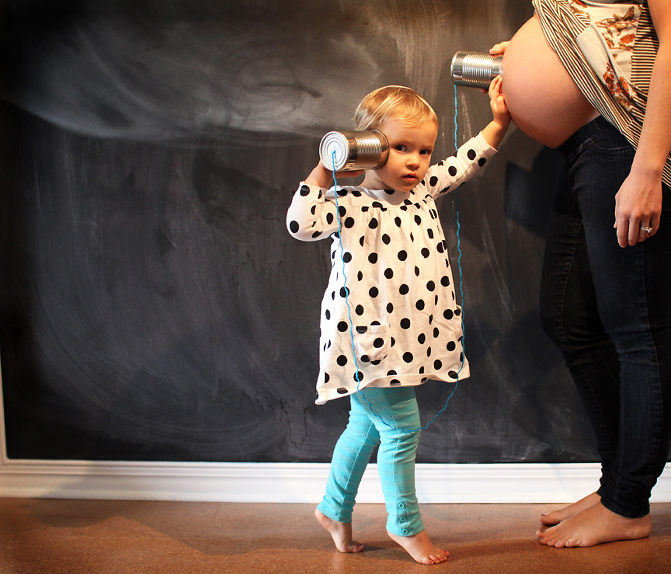 Daughter talking to mommys pregnant belly in Kitty Hawk, NC