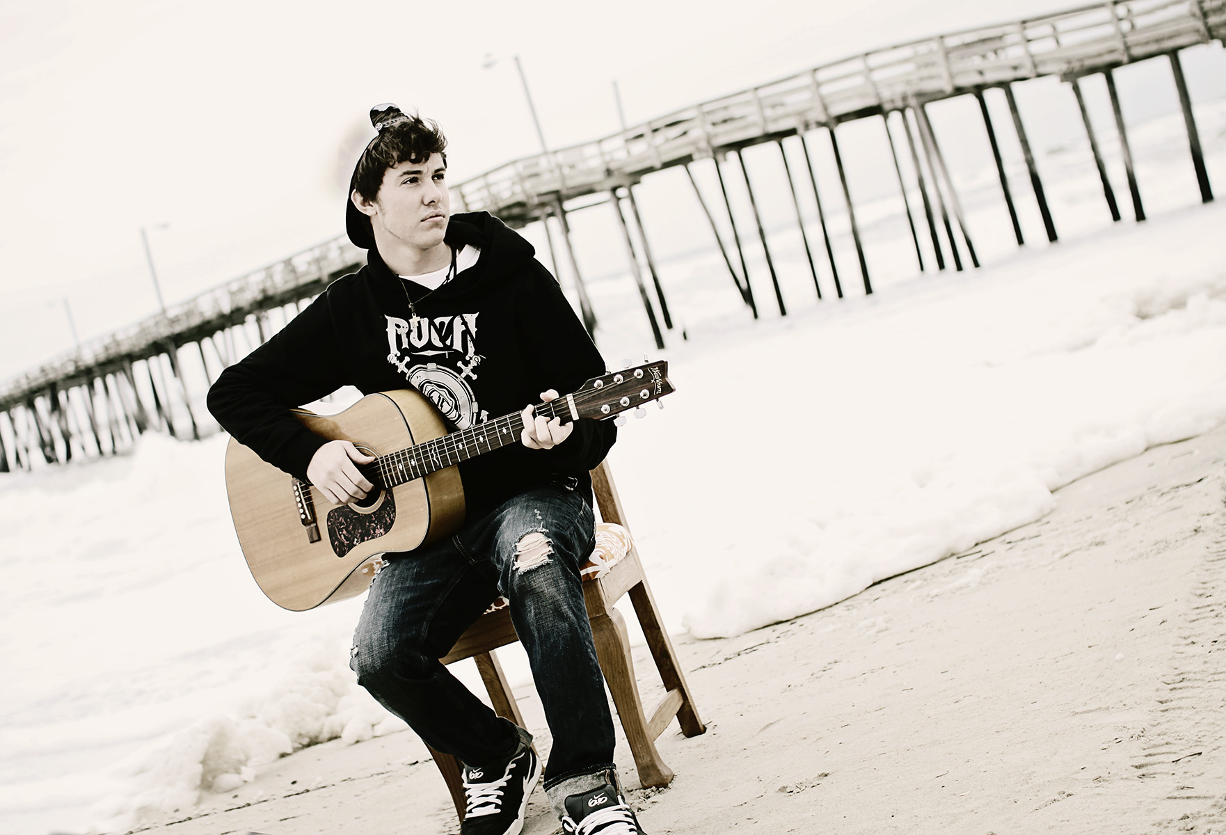 Senior guy playing guitar at the beach