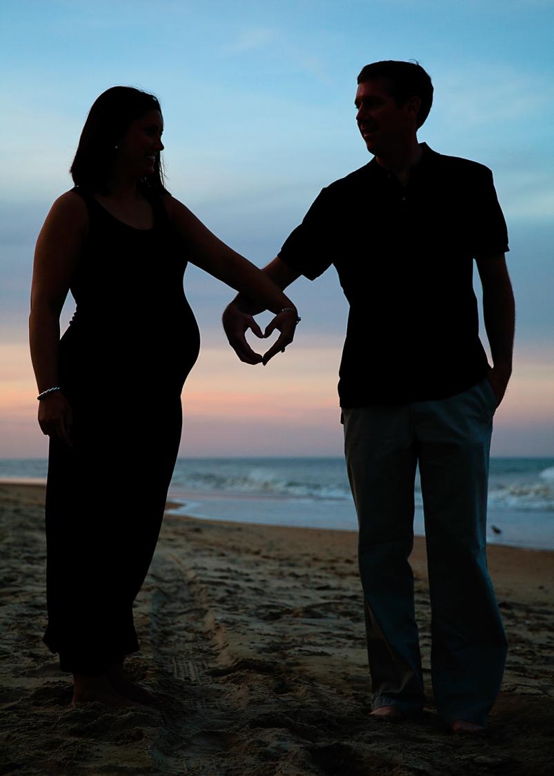 Maternity couple silhouette with heart silhouette