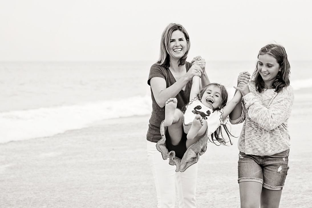 Little Samantha is swung in the air on the beaches of Nags Head NC