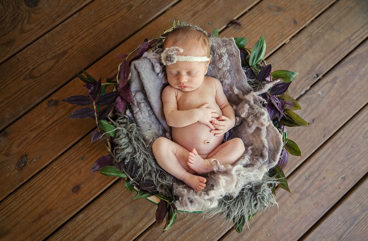 newborn in a wood bowl